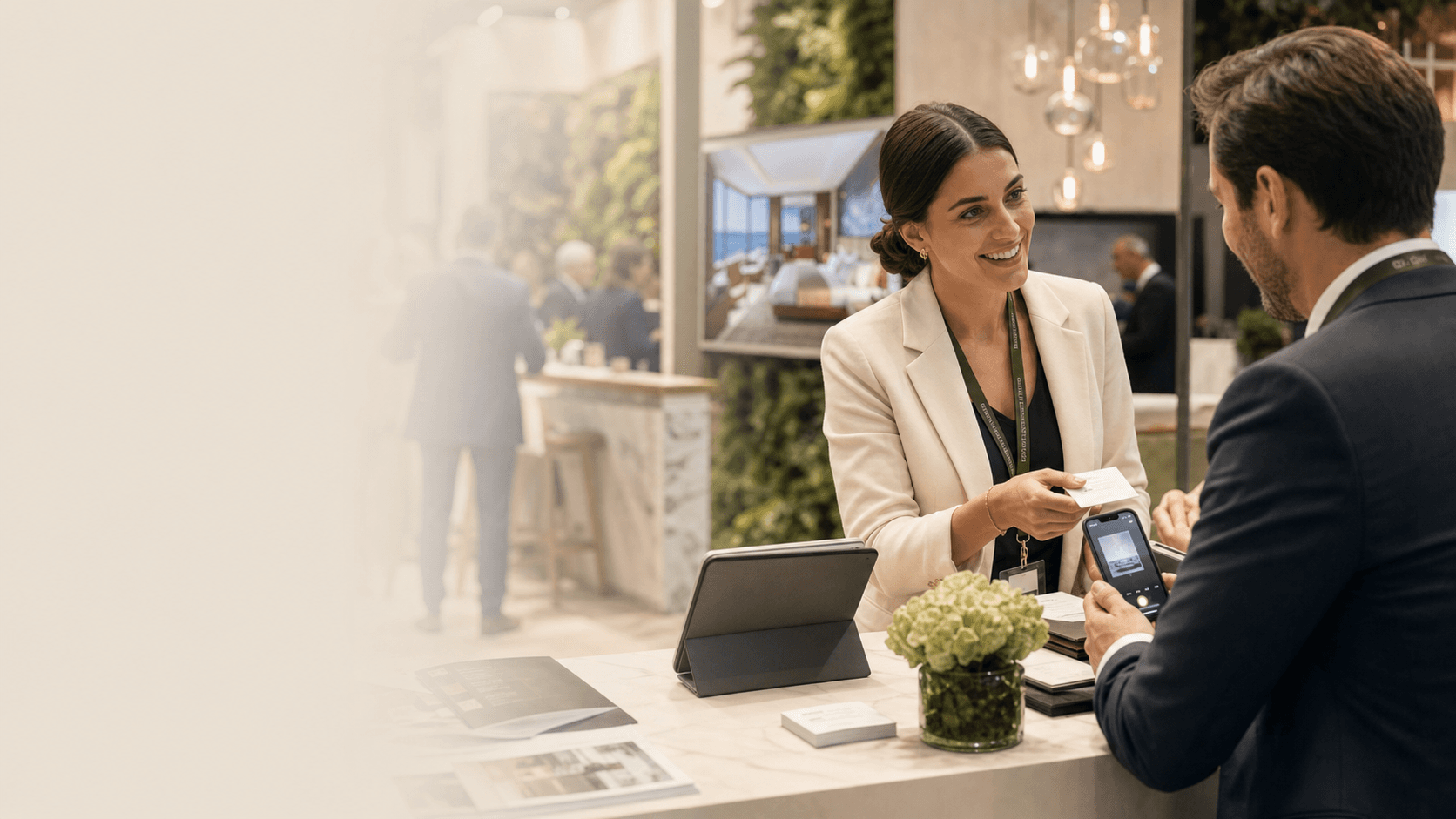 A sales professional exchanging a business card during a conference conversation